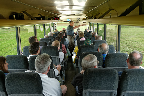 Terry Young, Assistant Director of Cemeteries for the Diocese of St. Petersburg, leads a bus tour of participants during the 2013 Smaller Cemetery Seminar's site tour of Calvary Catholic Cemetery.