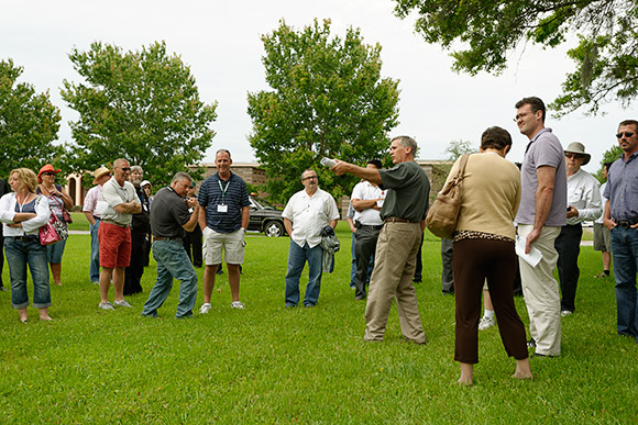 Participants look over one of the in-ground burial areas at Calvary Catholic Cemetery.