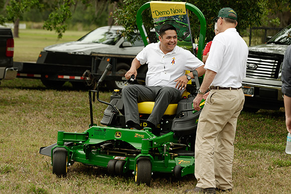 Joshua Perez, the Executive Director of the Cemeteries of Guam, Archdiocese of Agana, appears pleased with his hands-on demonstration of one of the riding mowers during the Equipment Showcase.