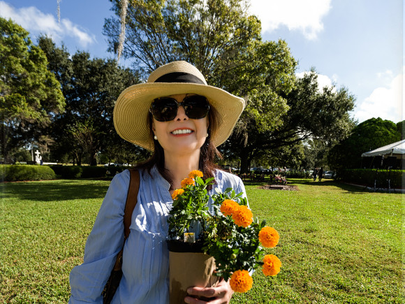 Alessandra Flanagan holds a flowerpot of mums that Franciscan Sister Rose Behrnard, asked her to place on the grave of her longtime friend, Father Roch Coogan, OFM. Father Coogan, who passed away on August 1, 2013, was a retired Air Force Chaplain and also was a chaplain at St. Anthony Hospital.