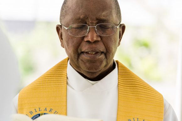 Father Hugh Chikawa in prayer at Mass on Memorial Day.