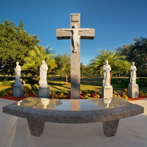 Statues of the four Evangelist, St. Luke, St. John, St. Mark and St. Matthew, flank the image of the Crudifixion of Christ behind the outdoor altar at Calvary Catholic Cemetery.