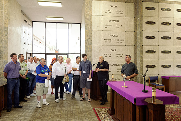 Father Ralph Argentino, Director of Cemeteries for the Diocese of St. Petersburg, explains the Month's Mind Mass, which is celebrated on the last Thursday of every month in the Chapel of the Resurrection, to a group with the Smaller Cemetery Seminar's Site Visit and Tour.
