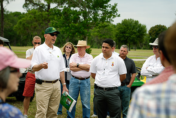 Keith Hoverstad, Manager of Government Sales for John Deere, talks about equipment selection for smaller cemeteries during the equipment showcase at Calvary Catholic Cemetery.