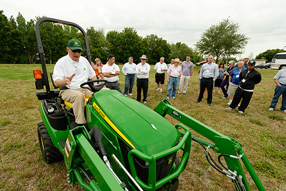 John Deere's Keith Hoverstad demonstrates one of his company's small tractors.