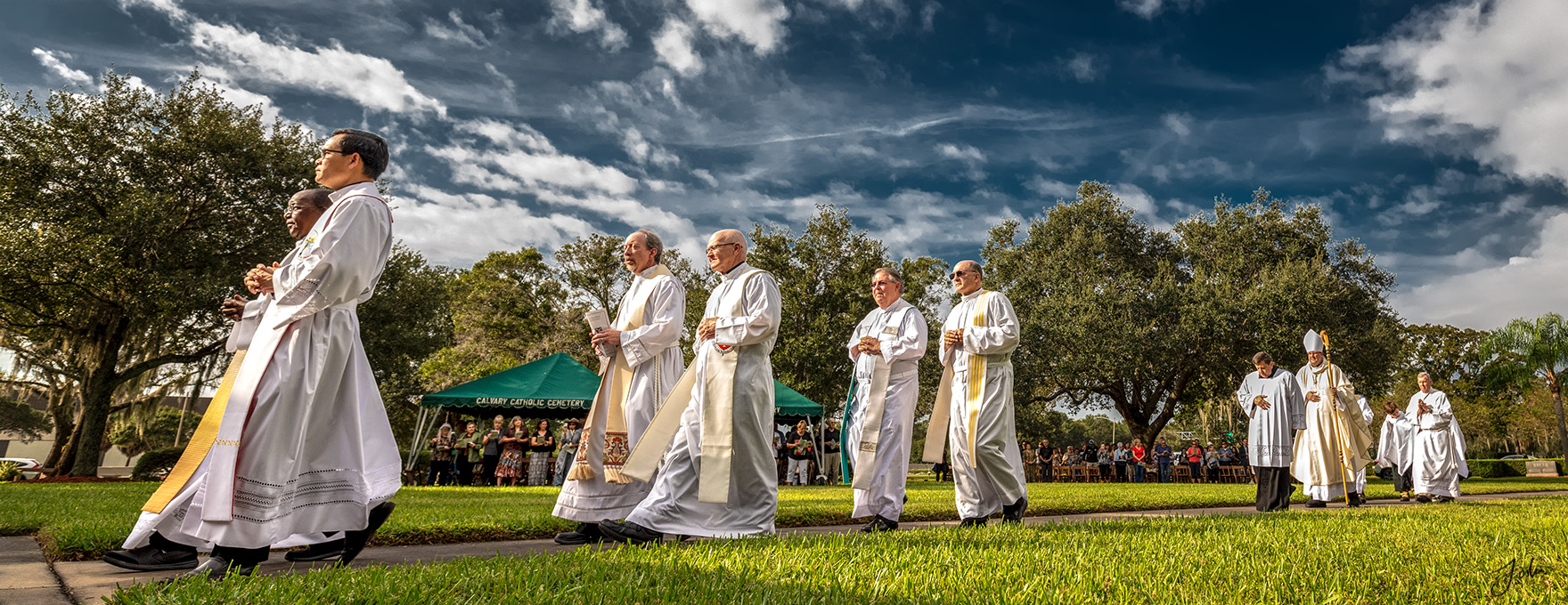 Most Reverend Gregory L. Parkes, left center, and priests and deacons of the Diocese of St. Petersburg process to the outdoor altar at Calvary Catholic Cemetery for Mass on All Souls' Day', November 2, 2020.