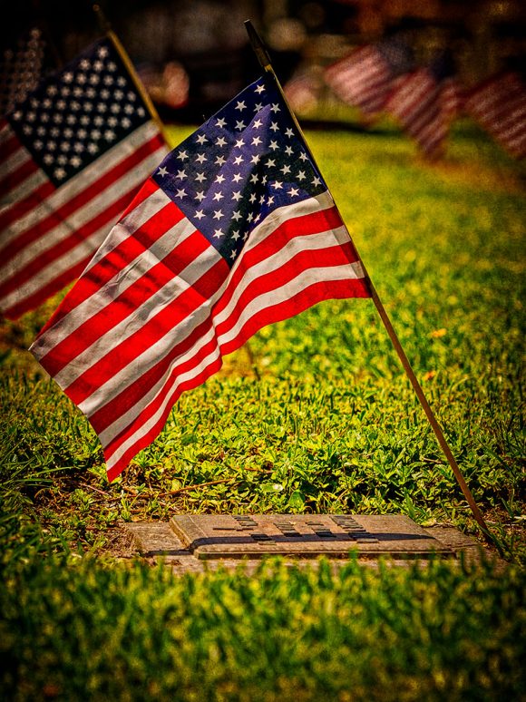 American Flags mark the graves of those who served in the U.S. Military and are buried at Calvary Catholic Cemetery.