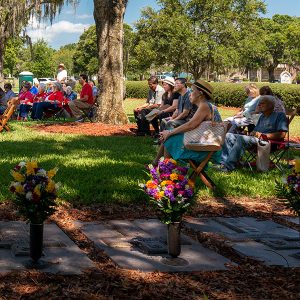 Some of the faithful take advantage of shade beneath one of the majestic oaks that flank the graves of departed bishops and priests who have served the Diocese of St. Petersburg.