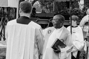 Father Hugh Chikawe, at right, reviews the liturgy prior to Mass with Father Ralph D'Elia.