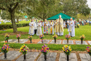 After Mass, Bishop Gregory Parkes, priests and deacon gather in prayer at the graves of some of their departed brethren who have served the Diocese of St. Petersburg.