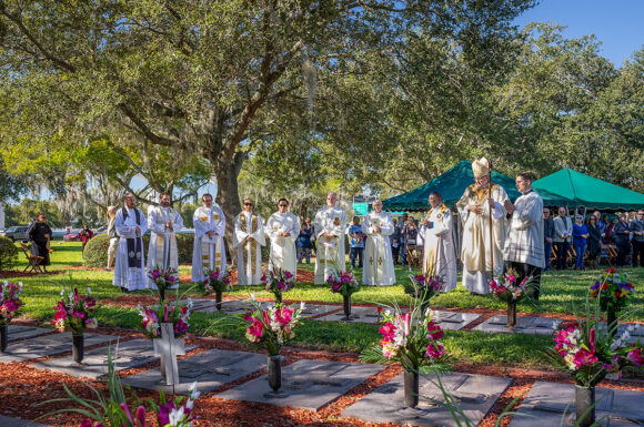 At the conclusion of Mass on All Souls' Day, Bishop Parkes and some priests of the Diocese of St. Petersburg gather at the graves of their departed brethren and sing, Salve Regina.
