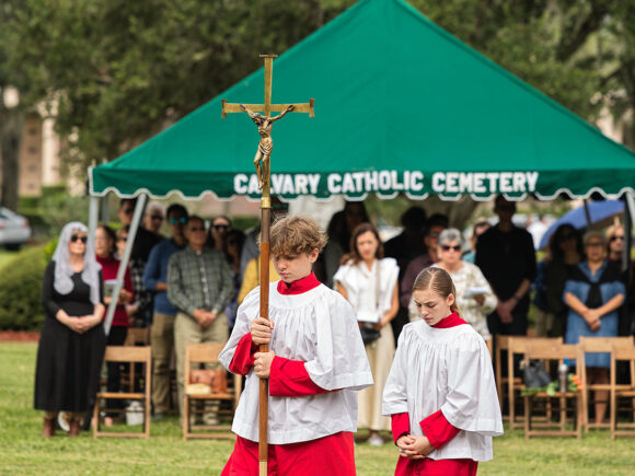 Cathedral of St. Jude the Apostle altar servers lead the procession for the 64th annual Mass on this All Souls’ Day. Msgr. John P. McNulty celebrated the first Mass at the outdoor altar on November 2, 1961 and this tradition has continued annually on All Souls’ Day and Memorial Day. Mass for the repose of souls is also celebrated at the Months Mind Mass on the last Saturday of every month in the Chapel of the Resurrection at 10:00 a.m.